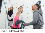 woman and man with ropes on the climbing gym. Стоковое фото, агентство Ingram Publishing / Фотобанк Лори