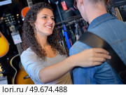 Lady holding woman's shoulder in musical shop. Стоковое фото, агентство Ingram Publishing / Фотобанк Лори