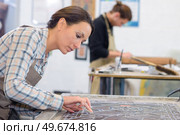 she is putting the glass together. Стоковое фото, агентство Ingram Publishing / Фотобанк Лори