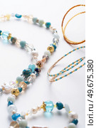 author trend necklace with different  beads  demonstrated  against white background. fashion and jewelry concept. Стоковое фото, агентство Ingram Publishing / Фотобанк Лори