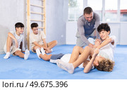Adolescent boys working on kimura maneuver during self-defense course. Стоковое фото, фотограф Яков Филимонов / Фотобанк Лори