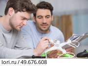 dad and son playing with toy drone. Стоковое фото, агентство Ingram Publishing / Фотобанк Лори