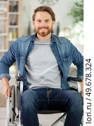 happy man sitting in wheelchair at home. Стоковое фото, агентство Ingram Publishing / Фотобанк Лори