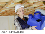 female working on industrial pipe. Стоковое фото, агентство Ingram Publishing / Фотобанк Лори