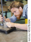 mechanical technician measuring with a caliper. Стоковое фото, агентство Ingram Publishing / Фотобанк Лори