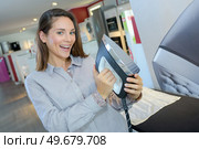 portrait of woman holding new iron. Стоковое фото, агентство Ingram Publishing / Фотобанк Лори