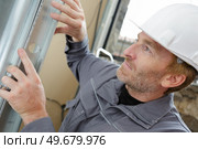 men and production of pvc windows. Стоковое фото, агентство Ingram Publishing / Фотобанк Лори