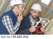 he is sceptical about those cables. Стоковое фото, агентство Ingram Publishing / Фотобанк Лори