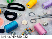 Handiwork. Old scissors, needles and set buttons on the table. Needlework. Sewing tools and accessories, set. Стоковое фото, агентство Ingram Publishing / Фотобанк Лори