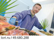 Portrait of man behind fish stall. Стоковое фото, агентство Ingram Publishing / Фотобанк Лори