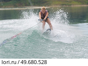 young woman study riding wakeboarding on a lake. Стоковое фото, агентство Ingram Publishing / Фотобанк Лори
