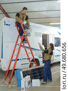 solar modules being placed on a caravan. Стоковое фото, агентство Ingram Publishing / Фотобанк Лори