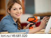 young woman with cordless drill ready for home repairs. Стоковое фото, агентство Ingram Publishing / Фотобанк Лори