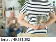 son offering a gift to his father. Стоковое фото, агентство Ingram Publishing / Фотобанк Лори