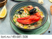 Seafood soup with lobster, mussels, prawns and fish. Seafood soup in ceramic bowl.. Popular seafood soup, Tom yum. Стоковое фото, агентство Ingram Publishing / Фотобанк Лори