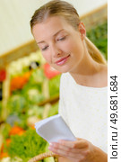 a lady consulting shopping list. Стоковое фото, агентство Ingram Publishing / Фотобанк Лори