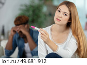 sad girl holding a pregnancy tester. Стоковое фото, агентство Ingram Publishing / Фотобанк Лори