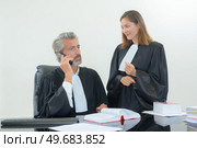 portrait of judges making telephone call. Стоковое фото, агентство Ingram Publishing / Фотобанк Лори