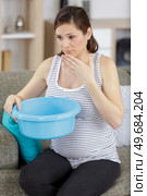 the pregnant woman lies on a sofa before vomiting. Стоковое фото, агентство Ingram Publishing / Фотобанк Лори