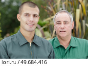 portrait of two men in garden. Стоковое фото, агентство Ingram Publishing / Фотобанк Лори