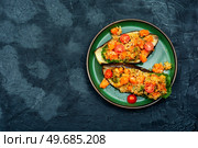 Baked eggplant stuffed with pumpkin and quinoa. Vegetarian food recipe. Space for text.. Baked stuffed eggplant, copy space. Стоковое фото, агентство Ingram Publishing / Фотобанк Лори
