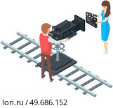 Girl holding movie clapper on camera. Filming starts, clap before new scene. Process of filming in pavilion. Man working with movie creation equipment. Cameraman shoots film on professional camera. Girl holding movie clapper on camera. Process of filming. Man working with film creation equipment. Стоковая иллюстрация, агентство Ingram Publishing / Фотобанк Лори