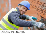 portrait of workman using metal reinforcing rods. Стоковое фото, агентство Ingram Publishing / Фотобанк Лори