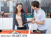 seller and costumer in a billiards shop. Стоковое фото, агентство Ingram Publishing / Фотобанк Лори