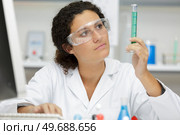 woman scientist checking liquid of test tube. Стоковое фото, агентство Ingram Publishing / Фотобанк Лори