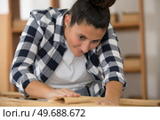 woman restore wooden furniture with sandpaper. Стоковое фото, агентство Ingram Publishing / Фотобанк Лори