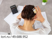 worried young woman in debt at home. Стоковое фото, агентство Ingram Publishing / Фотобанк Лори