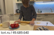 A fun-loving boy learns to make pizza, experimenting with toppings and enjoying every step of the process. Cooking magic. Стоковое видео, видеограф Ирина Старикова / Фотобанк Лори