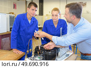 team of apprentices in the workshop. Стоковое фото, агентство Ingram Publishing / Фотобанк Лори