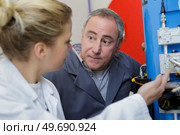 woman adjusting machine with spanner. Стоковое фото, агентство Ingram Publishing / Фотобанк Лори
