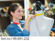 beautiful young woman in measuring dummy with tape. Стоковое фото, агентство Ingram Publishing / Фотобанк Лори
