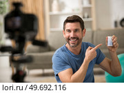 a male sport blogger recording video at home. Стоковое фото, агентство Ingram Publishing / Фотобанк Лори