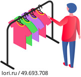 Choosing clothes in store, shopping concept. Male buyer chooses clothing in dressing room. Customer with dress hanging on hanger in mall. Man shopper stands in fitting room of store or boutique. Choosing clothes in store, shopping concept. Male buyer chooses clothing in dressing room. Стоковая иллюстрация, агентство Ingram Publishing / Фотобанк Лори