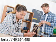 a couple fixing cooper pipes. Стоковое фото, агентство Ingram Publishing / Фотобанк Лори