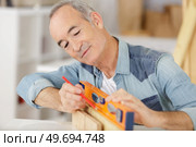 a happy senior carpenter at work. Стоковое фото, агентство Ingram Publishing / Фотобанк Лори