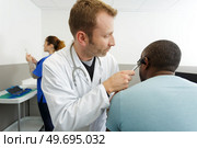 an otolaryngologist working with patient. Стоковое фото, агентство Ingram Publishing / Фотобанк Лори
