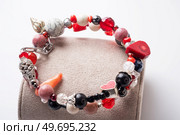 double  bracelet  with black and red  semipreciouse stones with natural lava, shungite,  hematite,  rhodonite, coral  and chains.  . Стоковое фото, агентство Ingram Publishing / Фотобанк Лори