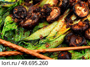 Chinese fried Pak Choi with shitake mushrooms and chopstick. Vegan food, close up. Fried bok choy or pak choi and shitake. Стоковое фото, агентство Ingram Publishing / Фотобанк Лори