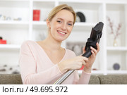 a young woman before hoovering. Стоковое фото, агентство Ingram Publishing / Фотобанк Лори