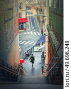 Outdoors scene with a man walking on the city streets in Asnieres sur Seine, a Paris suburb, France. Стоковое фото, агентство Ingram Publishing / Фотобанк Лори