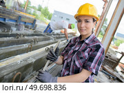 portrait of woman by reinforced concrete on construction site. Стоковое фото, агентство Ingram Publishing / Фотобанк Лори
