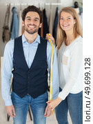 tailor standing near male client with measuring tape. Стоковое фото, агентство Ingram Publishing / Фотобанк Лори
