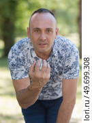 petanque player focused on aim. Стоковое фото, агентство Ingram Publishing / Фотобанк Лори