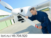 portrait of mechanic checking aircraft propellor. Стоковое фото, агентство Ingram Publishing / Фотобанк Лори