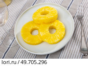 On table there is plate with summer dessert - round pieces of pineapple pulp. Стоковое фото, фотограф Яков Филимонов / Фотобанк Лори
