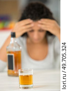 glass of liquor with woman on the background. Стоковое фото, агентство Ingram Publishing / Фотобанк Лори